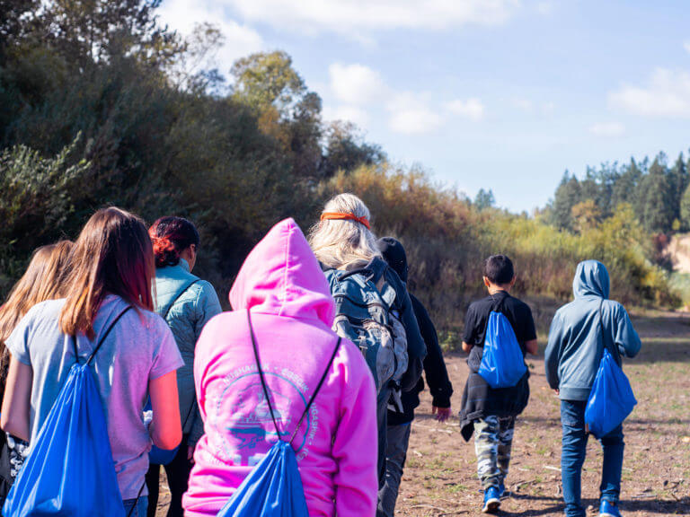 group of students hiking up a path